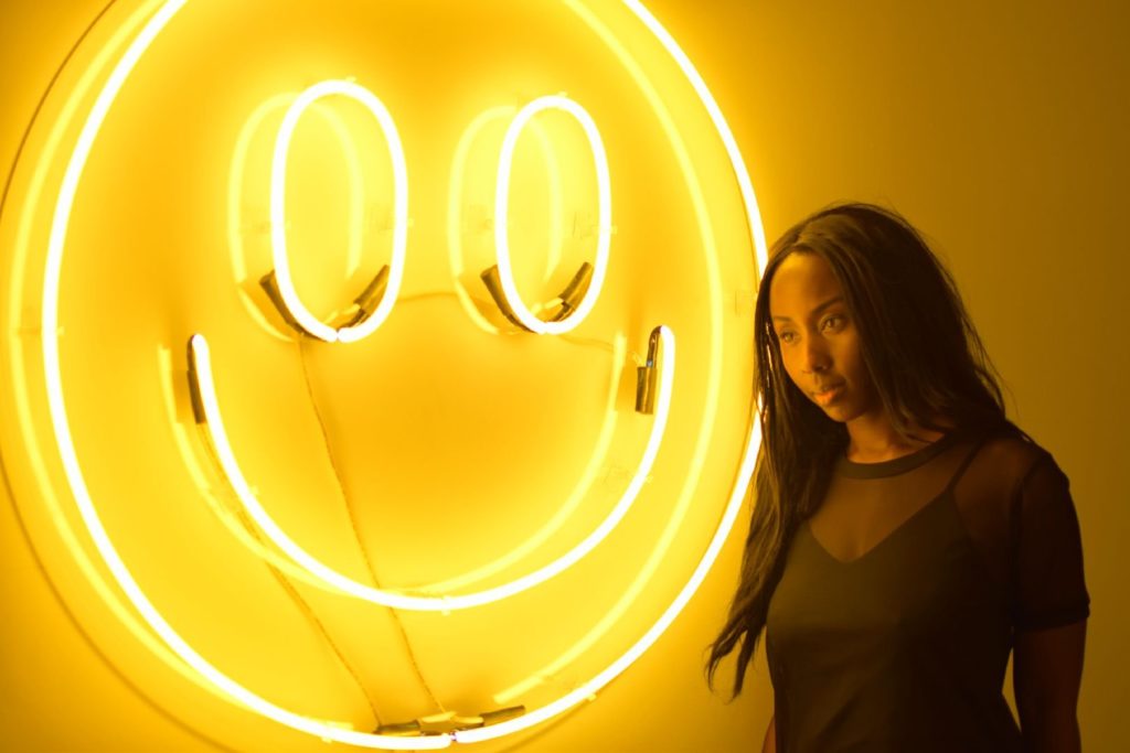 Amber Social in front of a bright smiley face